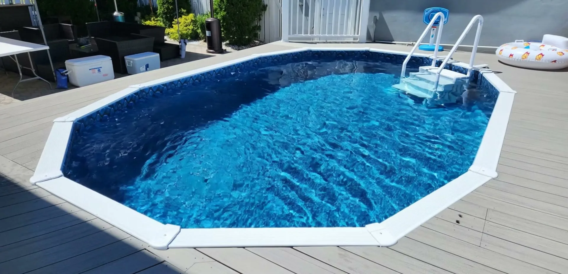 Finished Aquasport 52 semi-inground pool, filled, set level with a backyard deck